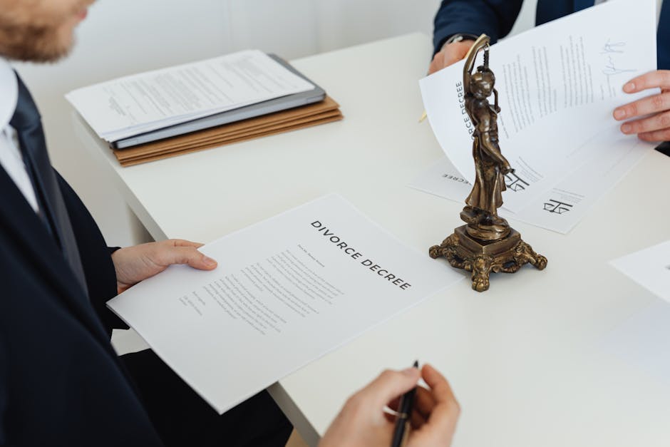 Two professionals discuss divorce decree documents, focusing on legal negotiations